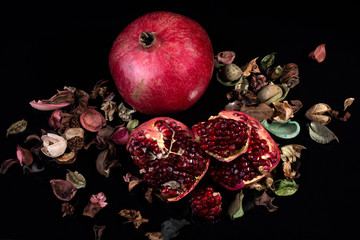 ripe pomegranate rustic style on black isolated background still life