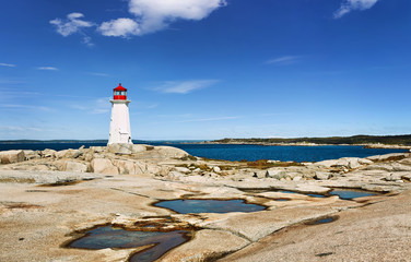 Panorama of Nova Scotia's iconic Peggys Cove Lighthouse on a sunny day