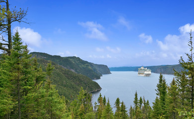 Panoramic view of the river Saguenay from Saguenay Fjord National park, Québec, Canada with cruise ship in distance.
