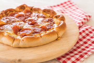Homemade Pepperoni Pizza on wood plate