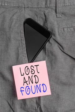 Handwriting text Lost And Found. Conceptual photo Place where you can find forgotten things Search service Smartphone device inside formal work trousers front pocket near note paper