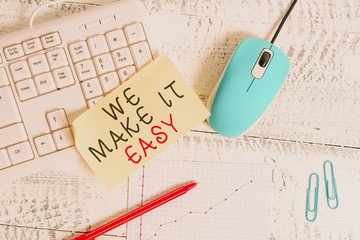 Text sign showing We Make It Easy. Business photo showcasing Offering solutions alternatives make an easier job ideas Writing equipments and computer stuffs placed above classic wooden table