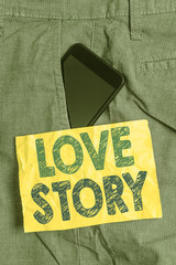 Writing note showing Love Story. Business concept for it is something such as a novel or movie about a love affair Smartphone device inside trousers front pocket note paper