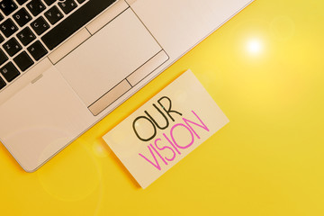 Word writing text Our Vision. Business photo showcasing serves as clear guide for choosing current and future actions Slim trendy silver open laptop square sticky notepad colored background