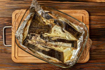Baked flounder in aluminum foil.