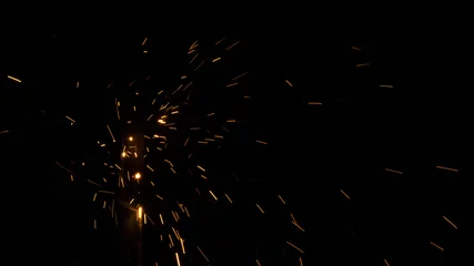 Fotobehang Glowing flow of steel metal welding spark dust particles shine in the sparkly dark background © katobonsai
