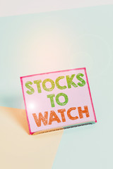 Word writing text Stocks To Watch. Business photo showcasing being heavy broker and watch every increase decrease Paper placed tilted above buffer wire on soft pastel multi colours backdrop