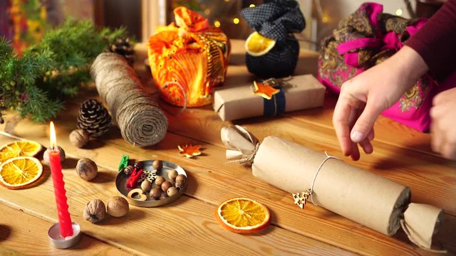 Eco-friendly gift box. Biodegradable brown parcel paper tied up with string &ndash; adding natural decorations. A waste-free Christmas. Reusable, compostable, recyclable wrapping 