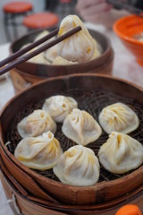 Delicious xiao long tang bao (Shanghai steamed soup dumplings). The broth-filled Shanghainese steamed pork dumplings is an iconic chinese dish in Shanghai.