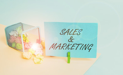 Writing note showing Sales And Marketing. Business concept for Promotion Selling Distribution of...