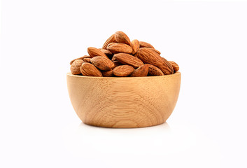 Almonds in a wooden bowl isolated on white background.