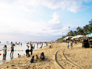 Bang Saen; Chonburi; THAILAND; 4 July 2018: Life rings; tables; chairs and umbrella for rent; clean sand and people chill at the beach with the clear blue sky.