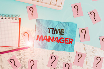 Handwriting text writing Time Manager. Conceptual photo process of planning and exercising conscious control of time Writing tools, computer stuff and math book sheet on top of wooden table