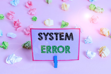 Writing note showing System Error. Business concept for instruction that is not recognized by an operating system Colored crumpled papers empty reminder pink floor background clothespin