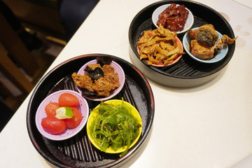 Traditional shanghainese pickled tomatoes with lemon juice, sesame oil seaweed, braised bamboo shoot, fried yellow fish, sweet and sour pork ribs and The braised wheat gluten Kao fu