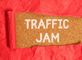 Handwriting text Traffic Jam. Conceptual photo a large number of vehicles close together and unable to move Cardboard which is torn in the middle placed above a wooden classic table