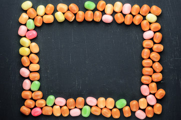 frame of multi-colored candies on a dark background with copy space - 305598851