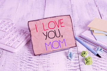 Conceptual hand writing showing I Love You Mom. Concept meaning Loving message emotional feelings affection warm declaration Notepaper on wire in between computer keyboard and sheets