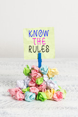 Writing note showing Know The Rules. Business concept for Learn the accepted principle or instructions to follow Reminder pile colored crumpled paper clothespin wooden space