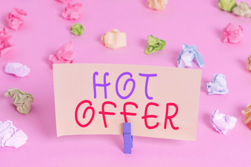 Word writing text Hot Offer. Business photo showcasing product or programme that is offered at reduced prices or rates Colored crumpled papers empty reminder pink floor background clothespin