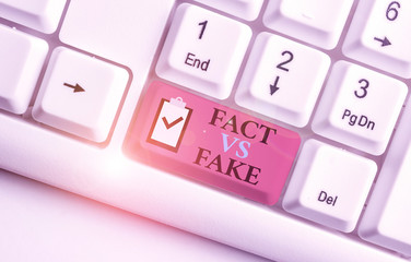 Writing note showing Fact Vs Fake. Business concept for Rivalry or products or information...