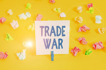 Word writing text Trade War. Business photo showcasing a situation in which countries try to damage each other s is trade Colored crumpled papers empty reminder white floor background clothespin