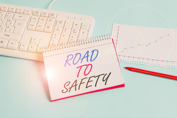 Text sign showing Road To Safety. Business photo showcasing Secure travel protect yourself and others Warning Caution Paper blue desk computer keyboard office study notebook chart numbers memo