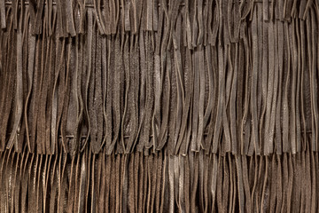 Genuine leather fringe texture. Boho style decorative element. A close-up of a bohemian accessory.