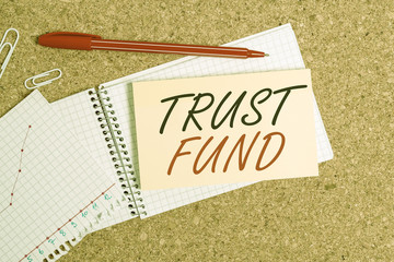 Handwriting text Trust Fund. Conceptual photo money that is being held by the trustees for the beneficiaries Desk notebook paper office cardboard paperboard study supplies table chart
