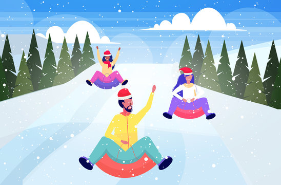 people in santa hats sledding on snow rubber tube christmas new year winter holidays activities concept mix race friends having fun snowy mountains landscape background horizontal full length vector