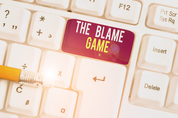 Text sign showing The Blame Game. Business photo text A situation when showing attempt to blame one another White pc keyboard with empty note paper above white background key copy space