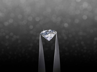 brillliant round diamond in tweezer on black shining bokeh background. concept for chossing best...