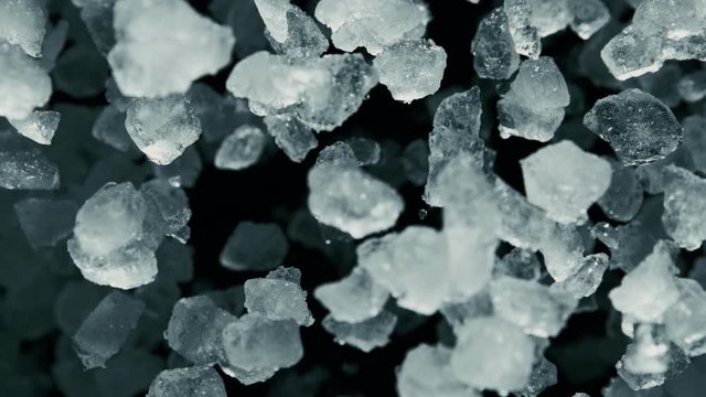 Super Slow Motion of exploding crushed ice towards camera, close-up