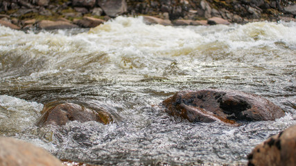 Streams of water mountain river and stones closeup