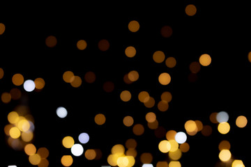 big yellow golden bokeh for background on black. Christmas lights.