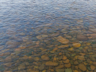 stones pebbles under water in autumn