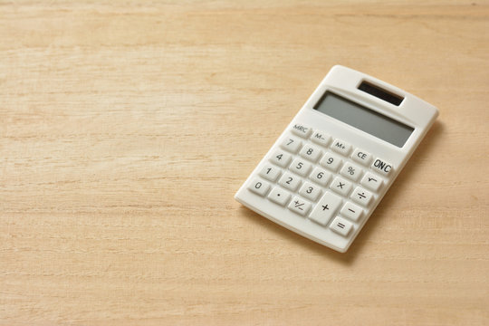 Calculator on a wooden table 