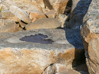 a hole in a heart shaped stone filled with water