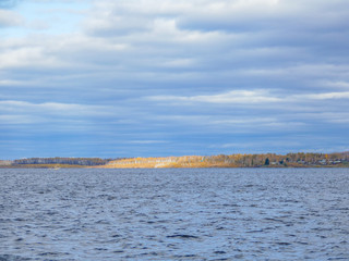 a large reservoir in the autumn cloudy sky and hill