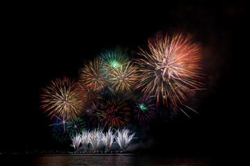 Colorful fireworks of various colors at night with celebration and anniversary concept