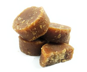 Jaggery isolated brown sugar in solid form on a white background.