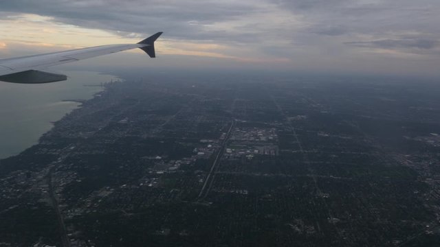 Aerial view of Chicago Illinois over Downtown and Lake Michigan out of plane window 4k