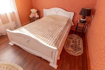 White antique furniture in a bedroom with red walls.