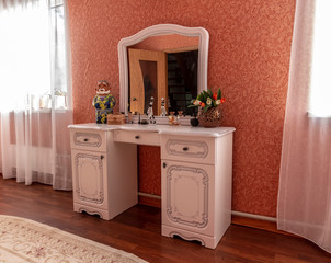 White antique furniture in a bedroom with red walls.