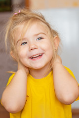 Portrait of a little smiling girl indoors