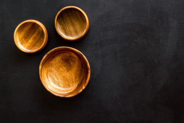 Making wooden dishes. Empty bowls on black background top view copy space