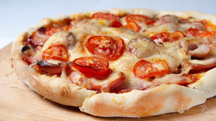 little homemade pizza lies on a wooden board