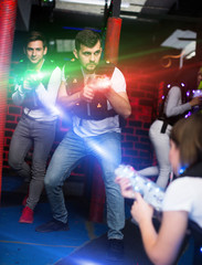 Excited guy laser tag player in bright beams