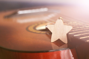 Wooden star and guitar so close