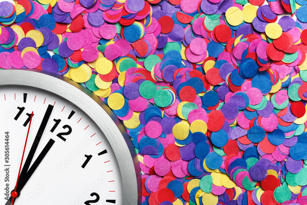 Poster close-up of a clock on colorful confetti. copy space
